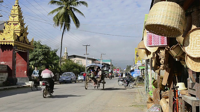 缅甸掸邦茵莱湖Nyaungshwe，马车在街道上奔跑，街道上有商店视频素材