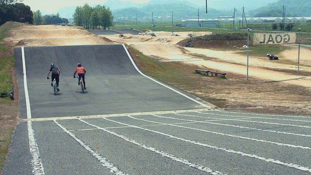 两名女运动员在小轮车跑道上赛跑视频素材