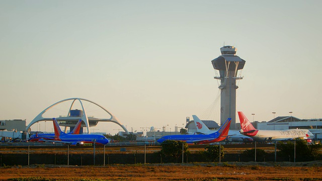 洛杉矶国际机场的控制塔和主题餐厅，韩亚航空的波音747-400在接近地面的框架视频素材