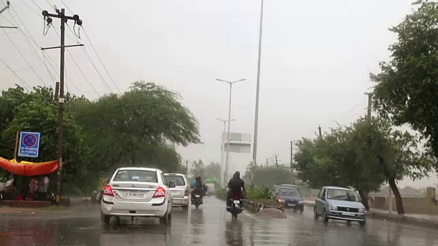 在城市里开车在雨季，从里面看视频素材