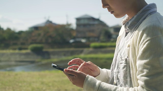 女人在城市里使用智能手机视频素材