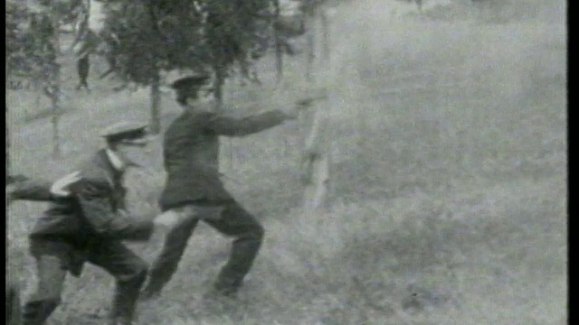 1915年Keystone Kops跑下草坡，转身朝画面外的人射击视频素材