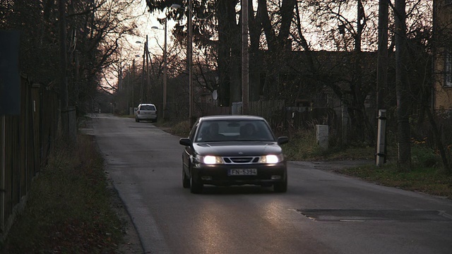 MS View of Car moving on road through residential area /拉脱维亚视频素材