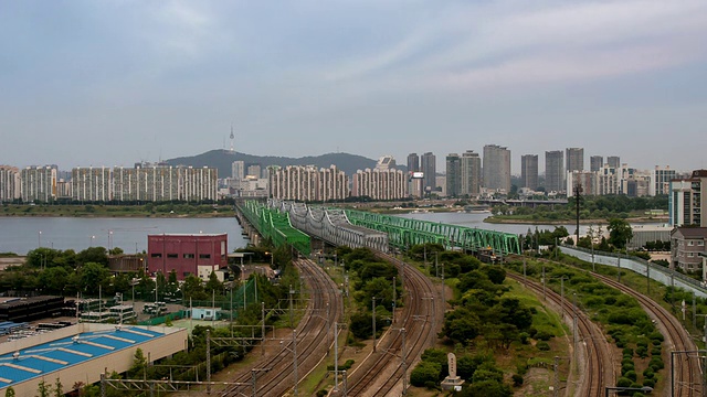 日落时，火车经过汉江cheolgyo(铁路桥)的景象/韩国首尔视频素材