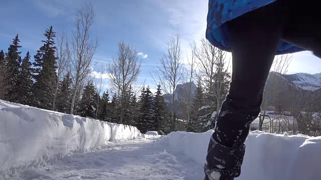 小男孩快乐地走在雪道上视频素材