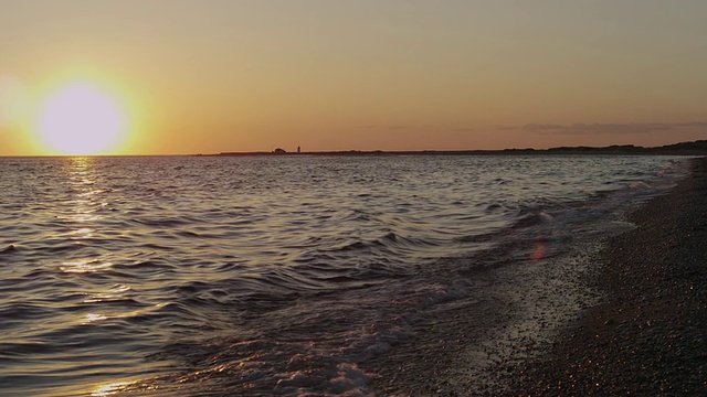 鳕鱼角的鲱鱼湾日落，灯塔和海浪。视频素材