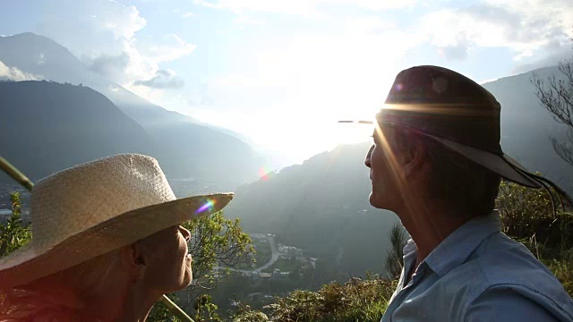 一对夫妇在山谷上方的山径边停下来视频素材