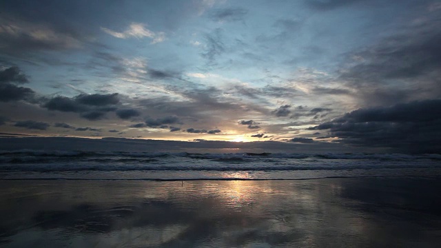 日落时小海浪拍打着海滩视频素材