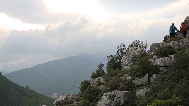 徒步夫妇攀登岩石山脊山脊之上的山谷，山脉视频素材