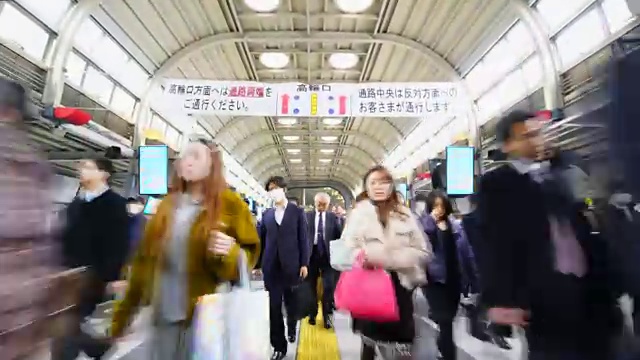 在JR品川站彩虹路通道，早上上下班的人群非常拥挤。JR品川站彩虹路的清晨通勤场景。视频素材