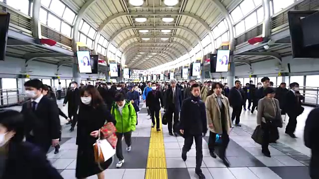 在JR品川站彩虹路通道，早上上下班的人群非常拥挤。JR品川站彩虹路的清晨通勤场景。视频素材