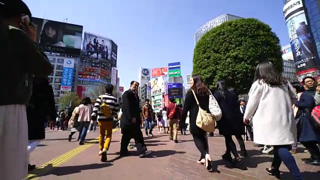 周日下午，镜头穿过涉谷十字路口前往涉谷中心。并捕捉城市景观和行人，在十字路口。视频素材