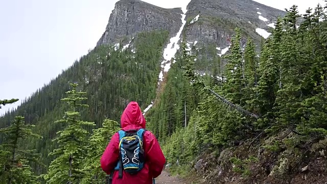 女人走在山间小路，在暴风雨中视频素材