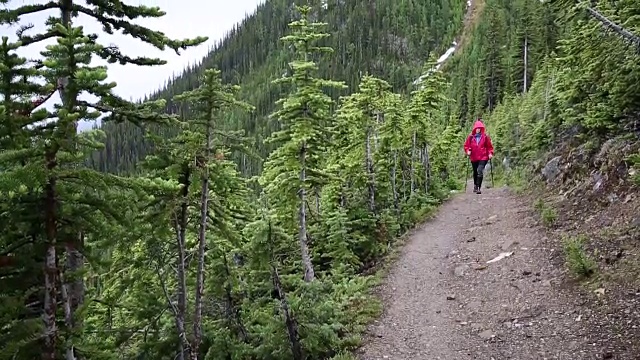 女人走在山间小路，在暴风雨中视频素材