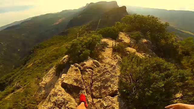 在加泰罗尼亚比利牛斯山脉的夕阳下，一个人从个人角度走在一个边缘山。视频素材