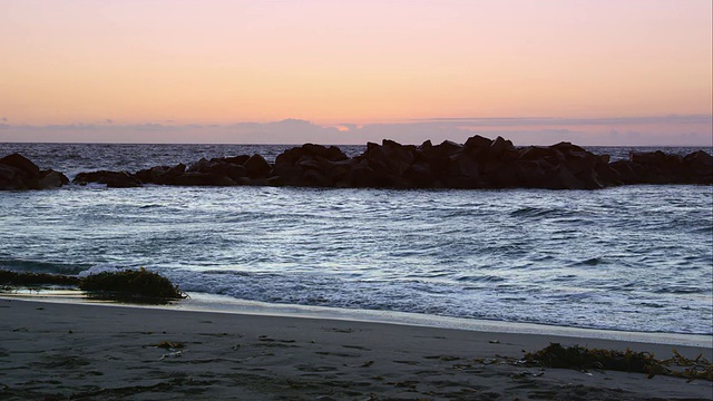 海浪来到海岸线上，撞击岩石的慢镜头。视频素材