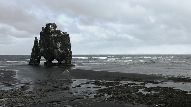 冰岛北部海岸的海滩上矗立着一个玄武岩海堆。视频素材