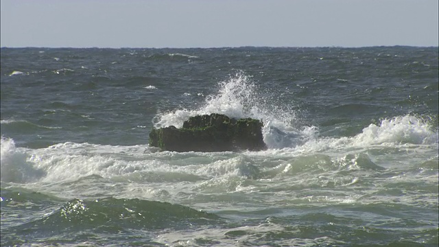 海浪围绕着地中海中的一块巨石。视频素材