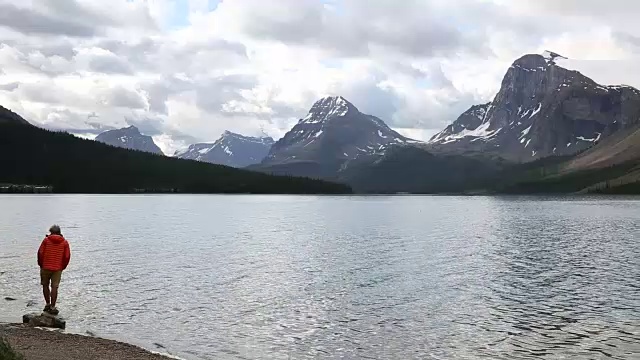 徒步者走到湖边，望向雪山视频素材