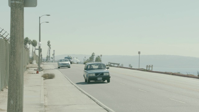 沿海岸道路行驶的汽车的中等角度。视频素材