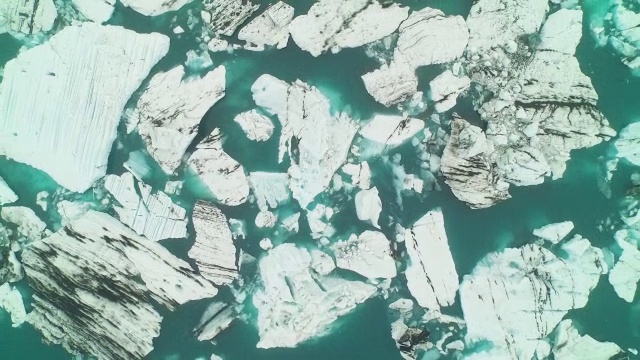 空中飞过JÃ¶kulsÃ±³冰川泻湖直接向下看，在冰岛急剧缩小视频素材