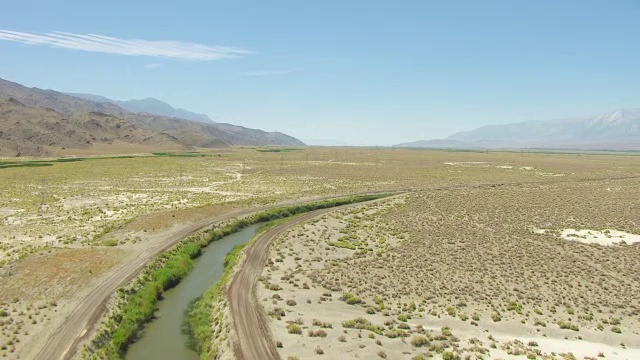 WS TU AERIAL POV视图欧文斯河与洛杉矶渡槽连接沙漠山谷，内华达山脉因约山的背景/美国加州视频素材