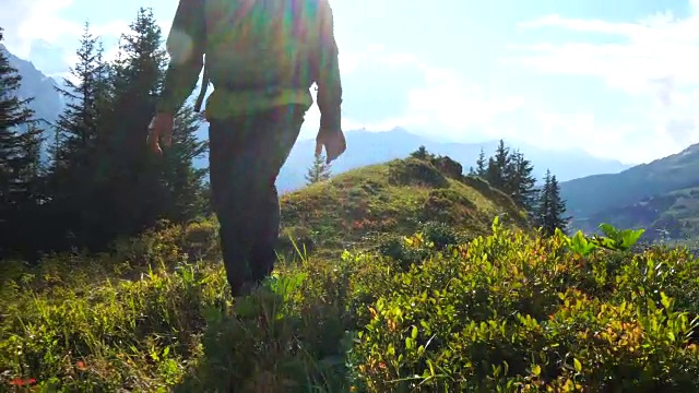 成熟的男人走在山脊边的草地上视频素材