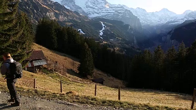 年轻人走在山间草地的小路上视频素材