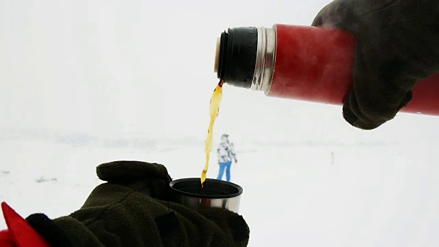 在滑雪道上用热水瓶盛满了茶视频下载