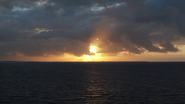 在墨西哥坎昆美丽的金色夕阳中，空中漂浮在海面上视频素材