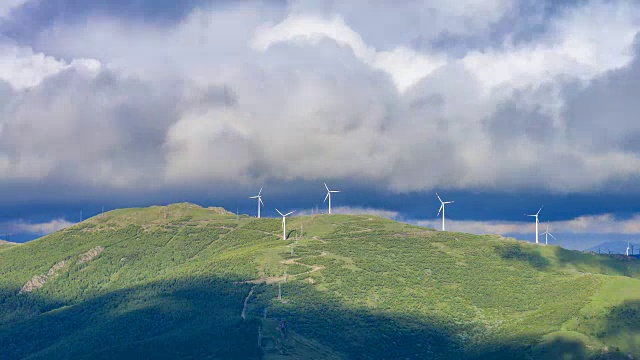 夏日的云朵飞过山顶的风电场视频素材