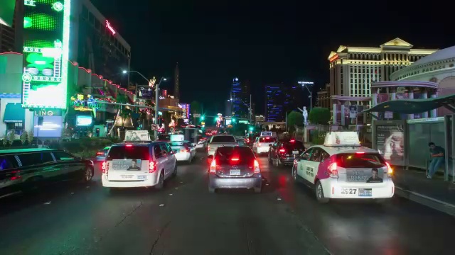 WS POV T/L夜间在街道上行驶的汽车，背景是酒店建筑/美国内华达州拉斯维加斯视频素材