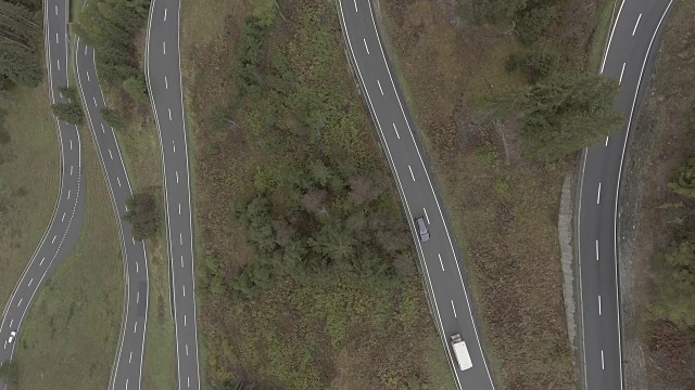 汽车在树木中蜿蜒的道路上移动的鸟瞰图，Flueela Pass，瑞士视频素材