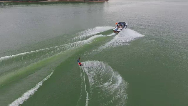 尾流板，尾流冲浪和在美丽的水极限运动乔治亚湖上的尾流滑冰，前翻，后翻，扭转和擦除跟踪揭示4k运动视频素材