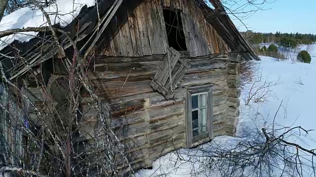 一个典型的西伯利亚村庄。冬天。房顶上有很多雪。传统的俄罗斯木屋是一间小屋。视频素材