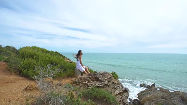 美丽的女人在大自然中独自举起双臂视频素材