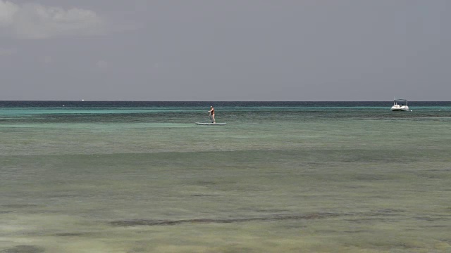 女人在清澈的海水上划桨视频下载