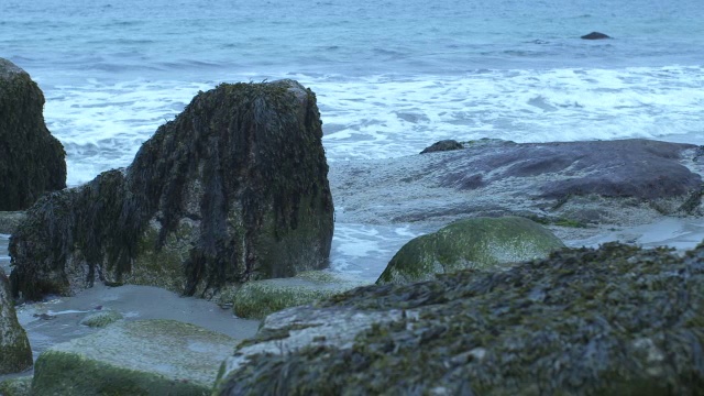 潘从左到右的海浪击中了岸上的岩石。可能是海滩。可能是湖泊或海洋。视频素材