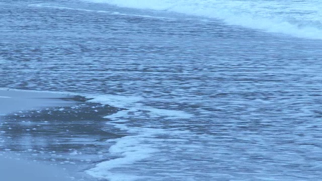 中等角度的海浪撞击海滩或海岸。可能是海洋或湖泊。视频素材