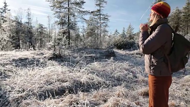 女人站在山上暖手视频素材