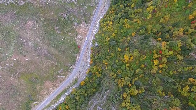 鸟瞰图农村公路之间的秋天植被在山区，甘肃，中国。视频素材