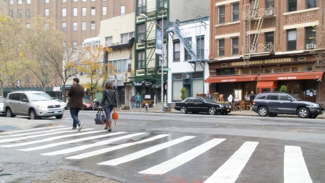 城市街道的广角。可见汽车、行人和店面。视频素材