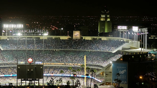 美国加利福尼亚州洛杉矶市的道奇体育场(T/L WS HA Dodger stadium)晚上挤满了观众，背景是市政厅和城市天际线视频素材