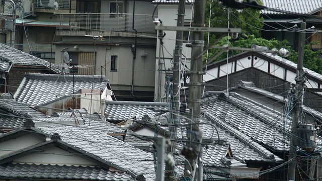 日本京都狭窄的街道上，传统的日本屋顶和游客视频素材