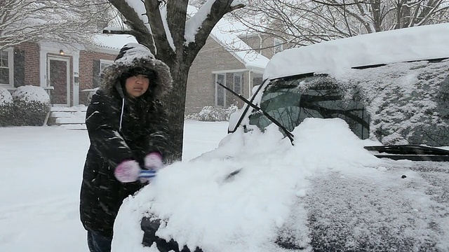 潘小姐年轻女子清理车上的雪/里士满，弗吉尼亚州，美国视频素材