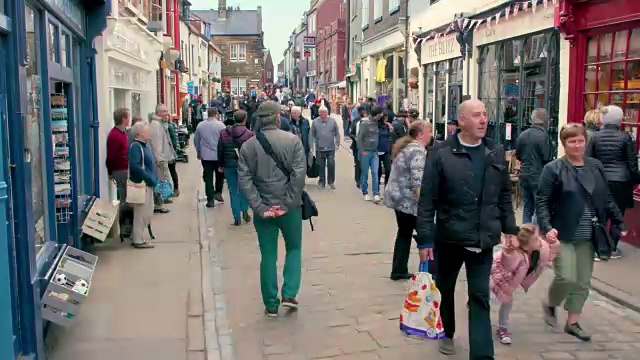 英国北约克郡惠特比教堂街，鹅卵石街上行走的人群视频素材