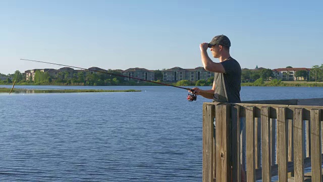 渔夫在湖水或河水中抛钓竿视频素材