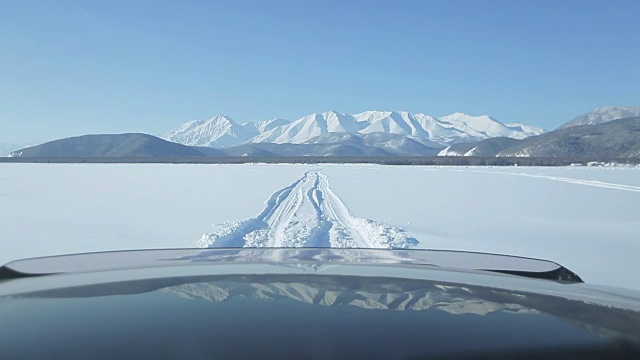 汽车在湖上结冰的道路上行驶视频素材