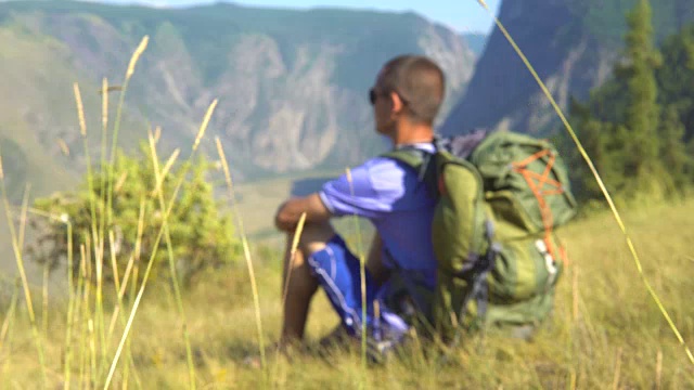 一个背着背包在山里的游客。视频素材