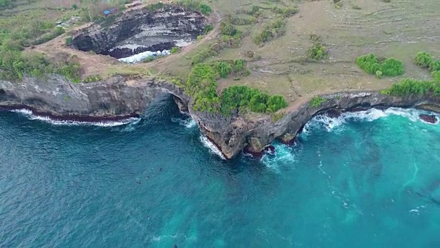 无人机4k摄像头鸟瞰图。岩石海岸与高悬崖，海浪与打破海岸，努沙佩尼达，帕西乌格，破碎的海滩。视频素材